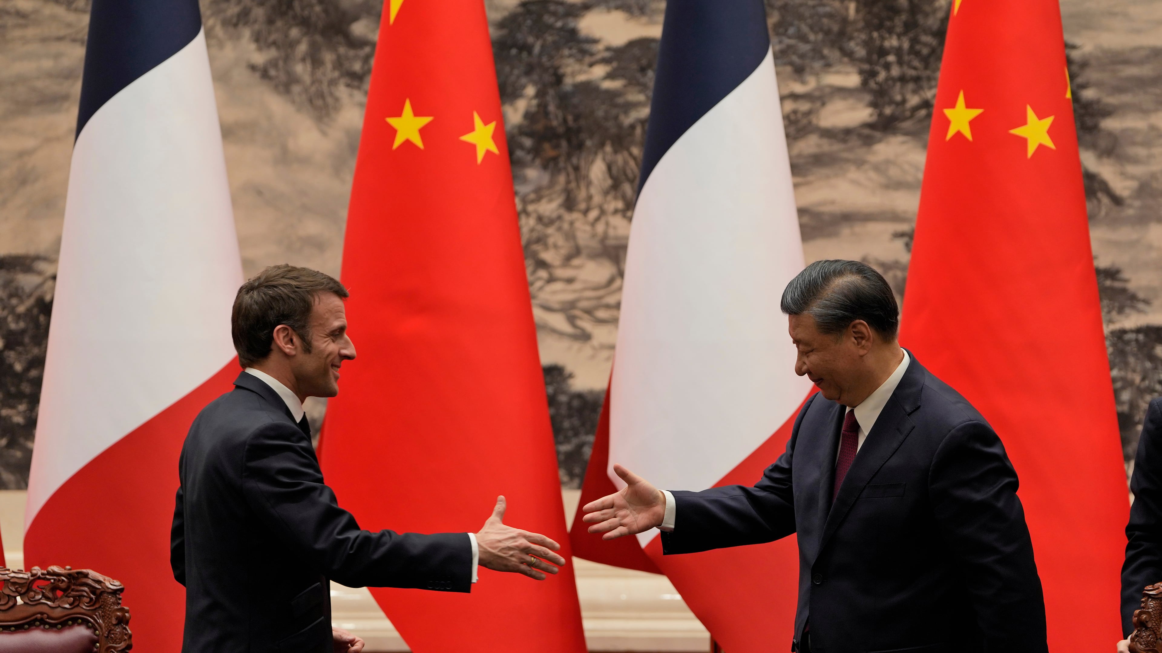 FILE - French President Emmanuel Macron, left, shakes hands with Chinese President Xi Jinping after meeting the press at the Great Hall of the People in Beijing on April 6, 2023. (AP Photo/Ng Han Guan, Pool, File)