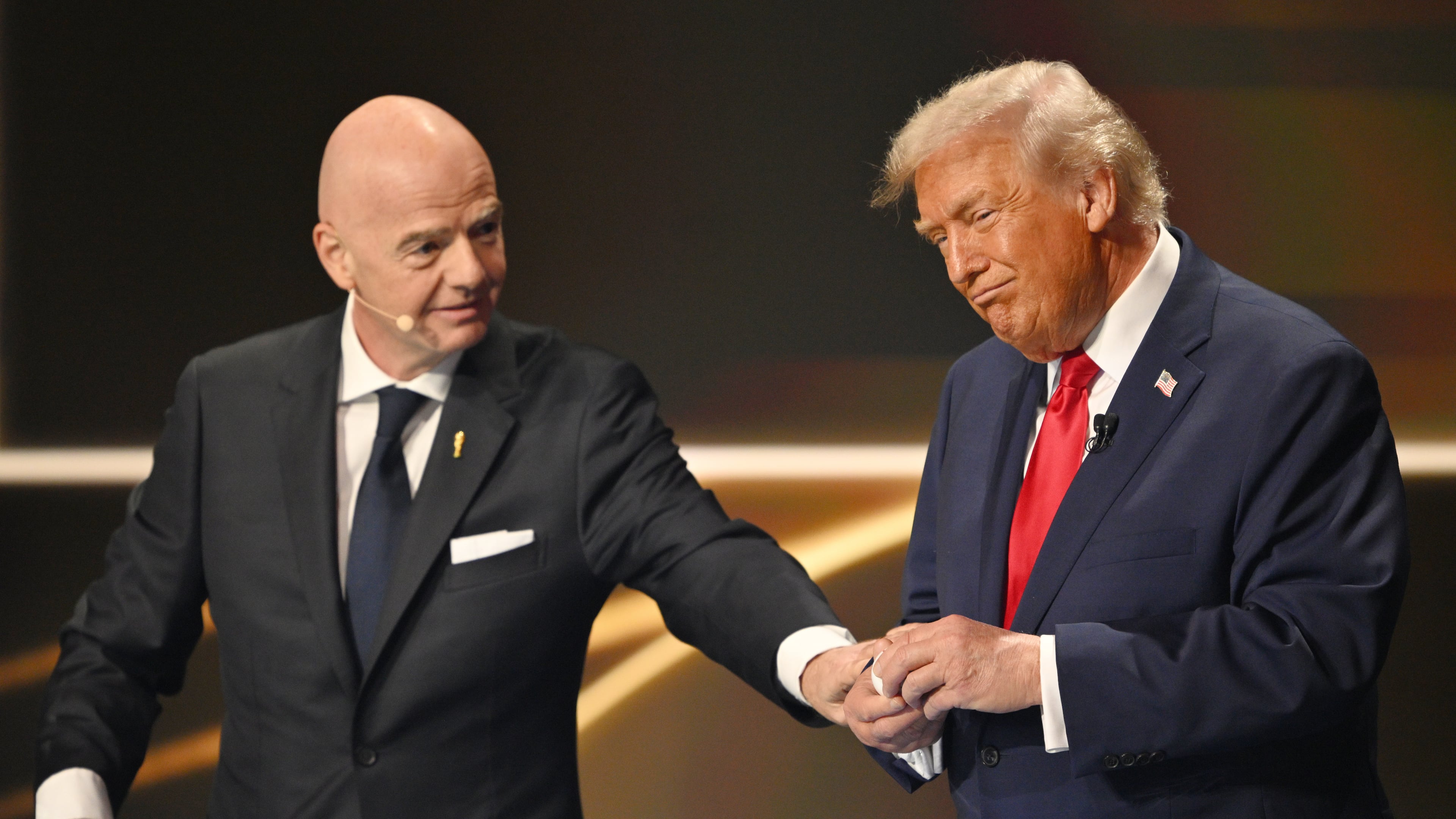 FIFA President Gianni Infantino pauses President Donald Trump during the draw for the 2026 soccer World Cup at the Kennedy Center in Washington, Friday, Dec. 5, 2025. (Mandel Ngan/Pool Photo via AP)