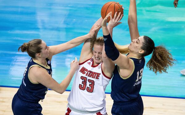 North Carolina State's Elissa Cunane (33) battles in the post against Georgia Tech's Lotta-Maj Lahtinen, left, and Lorela Cubaj, right, during an NCAA college basketball game in the semifinals of Atlantic Coast Conference tournament in Greensboro, N.C., Saturday, March 6, 2021. (AP Photo/Ben McKeown)