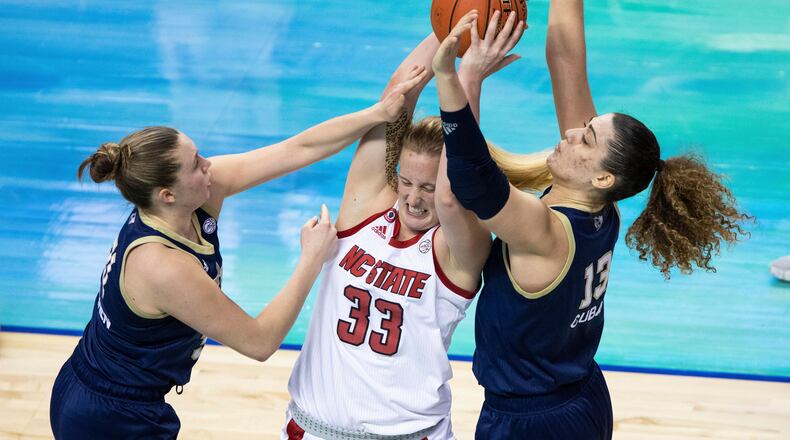 North Carolina State's Elissa Cunane (33) battles in the post against Georgia Tech's Lotta-Maj Lahtinen, left, and Lorela Cubaj, right, during an NCAA college basketball game in the semifinals of Atlantic Coast Conference tournament in Greensboro, N.C., Saturday, March 6, 2021. (AP Photo/Ben McKeown)