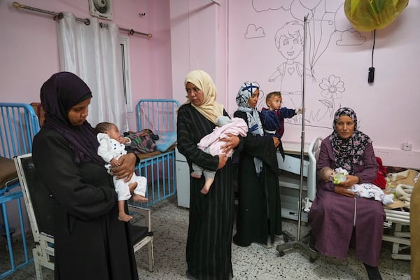 Palestinian women care for their babies at the malnutrition clinic in Nasser hospital, Khan Younis, Gaza Strip, Thursday, May 1, 2025. (AP Photo/Abdel Kareem Hana)