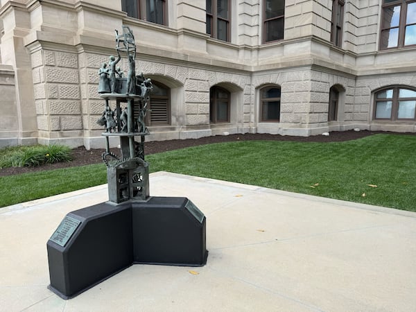 A monument to the first Black lawmakers elected to the Georgia Legislature stands outside the Capitol in Atlanta. Gov. Brian Kemp is expected to sign a bill authorizing a new monument to go inside.