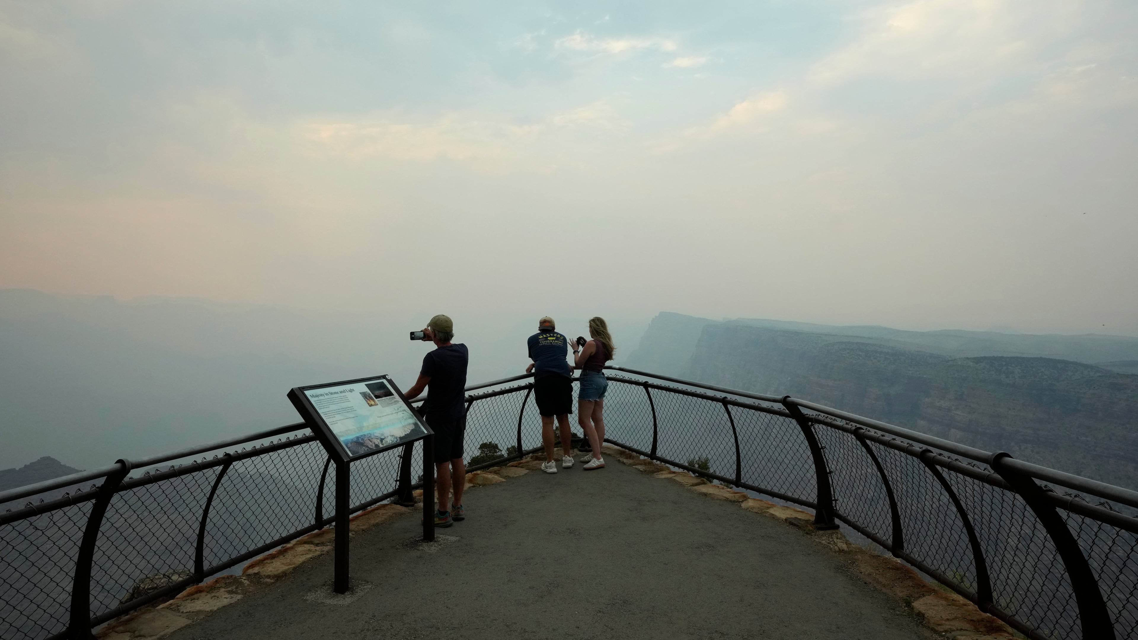 FILE - Smoke from the Dragon Bravo Fire moves over the Grand Canyon from the North Rim blocking the view for tourists at the Desert View overlook July 14, 2025, in Grand Canyon National Park, Ariz. (AP Photo/Ross D. Franklin, File)