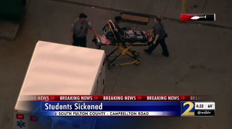 Authorities take a student out of the school on a stretcher and place him in an ambulance Thursday.
