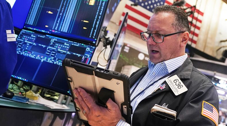 Trader Edward Curran works on the floor of the New York Stock Exchange, Wednesday, April 22, 2026. (AP Photo/Richard Drew)