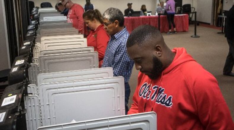 Middle school teacher Earnest Woodall casts his vote at Dekalb County Library-Dunwoody Branch on Saturday, Oct. 27, 2018.