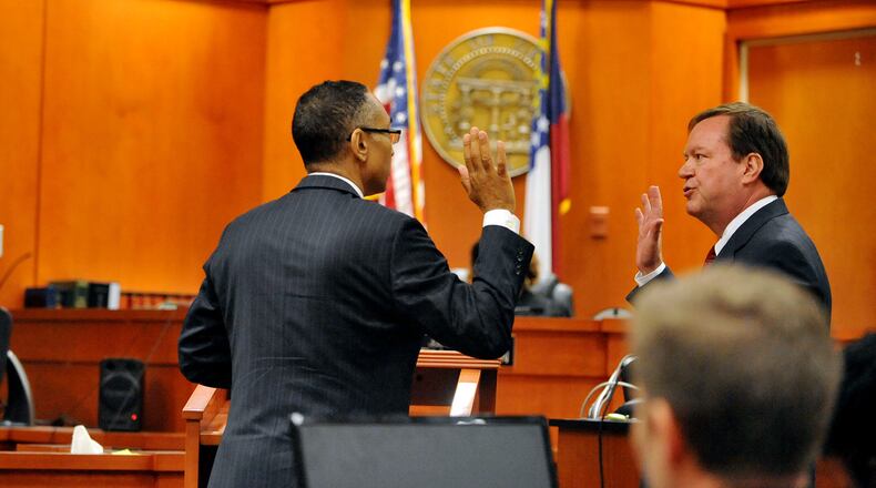 Suspended DeKalb County CEO Burrell Ellis is sworn in by defense attorney Craig Gillen before making a statement in his behalf before sentencing last year. Ellis was sentenced to 18 months in prison and 3½ years probation. KENT D. JOHNSON /KDJOHNSON@AJC.COM