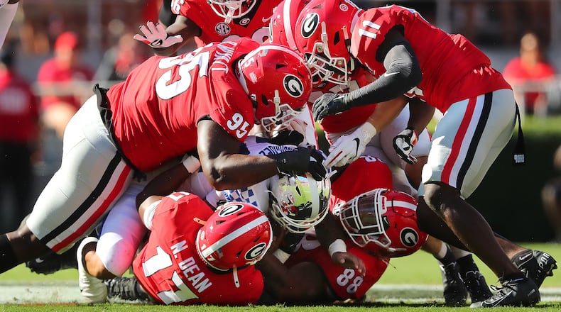 Georgia defenders smother Kentucky running back Chris Rodriguez to bring up third down and 16 yards during the first quarter Saturday, Oct. 16, 2021, at Sanford Stadium in Athens. Georgia won 30-13. (Curtis Compton / Curtis.Compton@ajc.com)