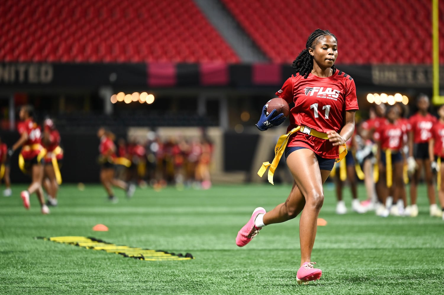 Winter Underwood runs drills during the 5th annual Girls Flag Football Showcase. (Daniel Varnado for the AJC)