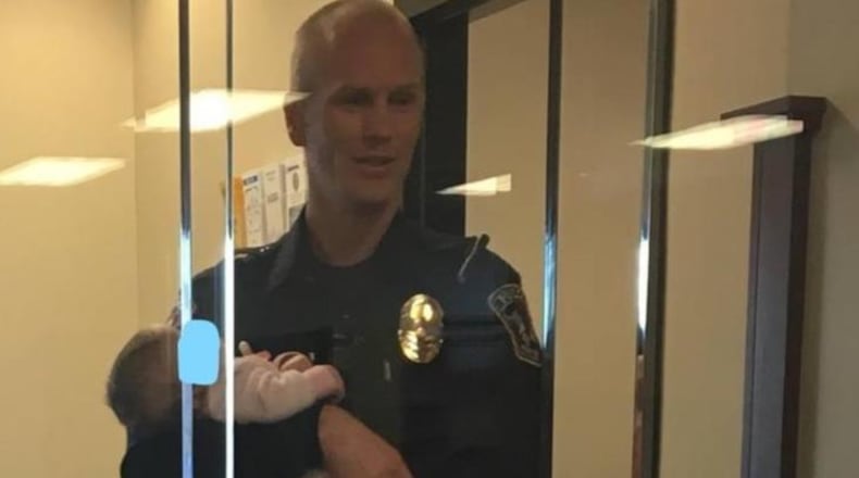 Photographs of a police officer in Utah caring for a baby have gone viral.