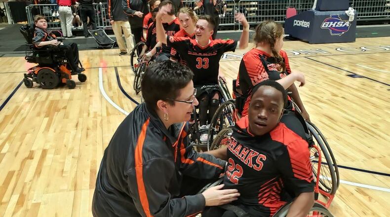Orlando Hicks, No. 22, celebrates with his coach. Dylan Thomas, No. 33, celebrates his game-winner.