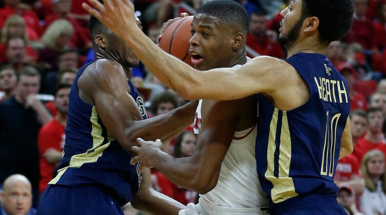North Carolina State’s Dennis Smith Jr. (4), center, drives past Georgia Tech’s Josh Okogie (5), left, and Josh Heath (11) during the first half of an NCAA college basketball game in Raleigh, N.C., Sunday, Jan. 15, 2017. (Ethan Hyman/The News & Observer via AP)