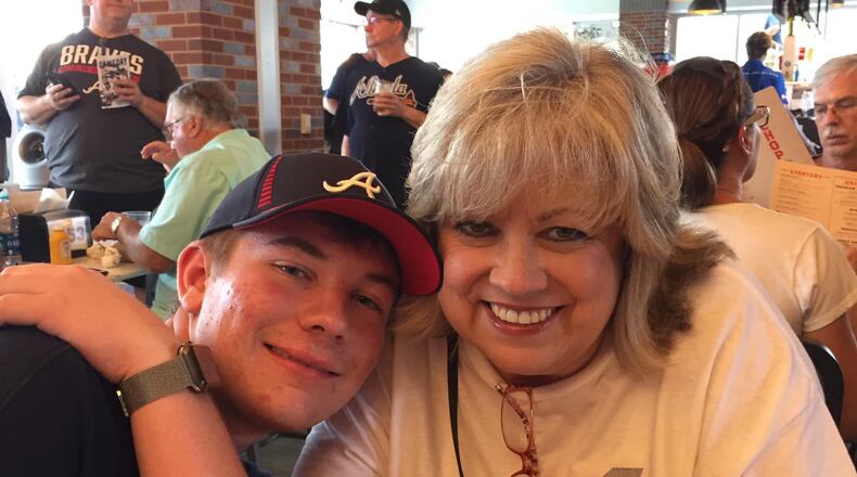 Sherry Clements Wilmot, seen here with her son J.T., said that the tipping ponit in overcoming her vaccine hesitancy was when a friend recommended that she write down every person she knew who died of COVID-19 (21 names), and everyone she knew who died of the vaccine. "Crickets. Zip. Zero," she now says. (Courtesy of Sherry Clements Wilmot)