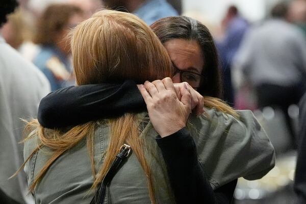 People hug at the Jewish Community Center of Greater Kansas City before a vigil for Sarah Milgrim and Yaron Lischinsky, Israeli Embassy staff members who were shot and killed while leaving an event at a Jewish museum in Washington, Thursday, May 22, 2025, in Overland Park, Kan. (AP Photo/Charlie Riedel)