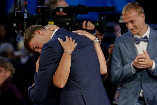 Cooper Flagg hugs family members after being selected first overall by the Dallas Mavericks In the first round of the NBA basketball draft, Wednesday, June 25, 2025, in New York. (AP Photo/Adam Hunger)