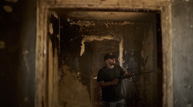 A Palestinian man cleans a room of a house damaged following an attack by Israeli settlers the previous day in the village of Sarra, near the West Bank city of Nablus, Saturday, July 25, 2026. (AP Photo/Leo Correa)