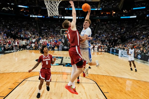 Alabama's Grant Nelson (4) defends Duke's Cooper Flagg (2) in the second half of a college basketball game during the Elite 8 round of the NCAA men's tournament Saturday, March 29, 2025, in Buffalo, N.Y. (AP Photo/Frank Franklin II)