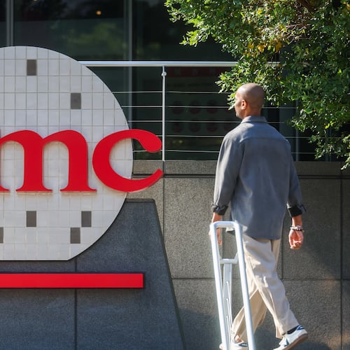 FILE -A worker walks past the logo of TSMC or Taiwan Semiconductor Manufacturing Corp., a Taiwanese multinational semiconductor contract manufacturing and design company, in Hsinchu, Taiwan, on Thursday, Jan. 29, 2026. (AP Photo/Daniel Ceng, File)