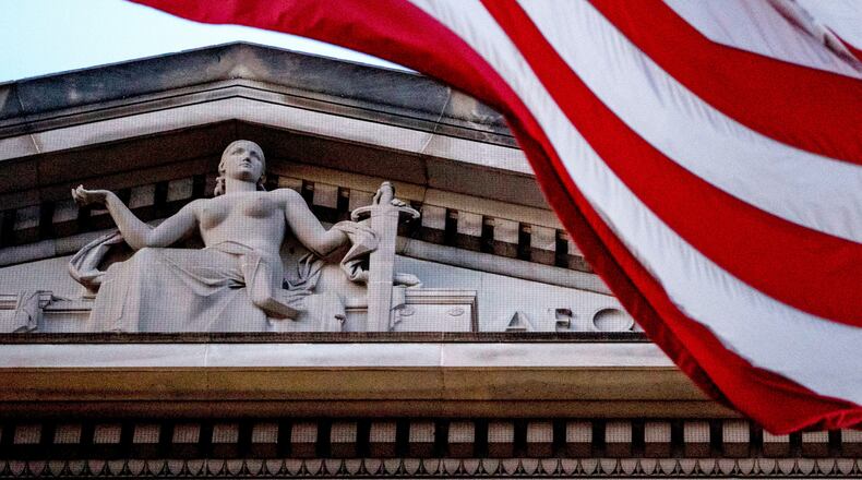 FILE - An American flag flies outside the Department of Justice in Washington, March 22, 2019. (AP Photo/Andrew Harnik, File)
