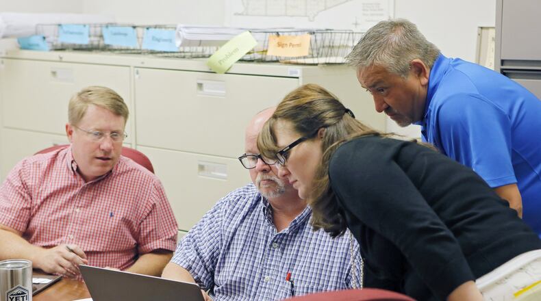 Tim Inglis (from left), Brian Epstein, Michelle Macauley, and Ringo McCollum prepare for the first day of building inspections on Wednesday. Monday was the first day of work for former Fulton County employees who are now working for the city of South Fulton. BOB ANDRES /BANDRES@AJC.COM