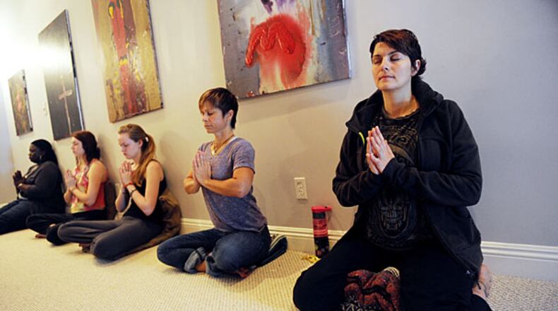 Colleen Comerford (right) meditates in a beginner's meditation class at Kashi Atlanta.