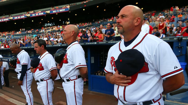 Atlanta Braves manager Fredi Gonzalez (from right to left), coaches Brian Snitker, Carlos Tosca, Terry Pendleton, players and fans observe a moment of silence for Ronald Lee Homer, 30, of Conyers, who fell to his death before the start of their game against the Phillies at Turner Field on Tuesday, August 13, 2013, in Atlanta. CURTIS COMPTON / CCOMPTON@AJC.COM