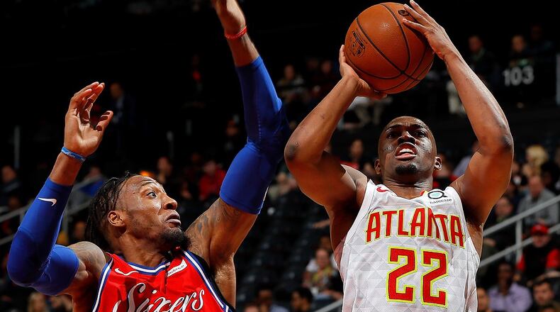 Robert Covington of the 76ers prepares to block a shot by Isaiah Taylor of the Hawks at Philips Arena on March 30, 2018. (Photo by Kevin C. Cox/Getty Images)