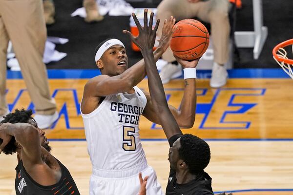 Georgia Tech forward Moses Wright (5) goes up for a shot as Miami center Nysier Brooks (3) and Miami forward Deng Gak, right, defend during the first half of an NCAA college basketball game in the quarterfinal round of the Atlantic Coast Conference tournament in Greensboro, N.C., Thursday, March 11, 2021. (AP Photo/Gerry Broome)