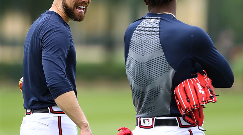 Atlanta Braves outfielder Ender Inciarte shares a laugh with Ronald Acuna while working in the outfield during spring training Wednesday, Feb. 20, 2019, at the ESPN Wide World of Sports Complex in Lake Buena Vista, Fla.