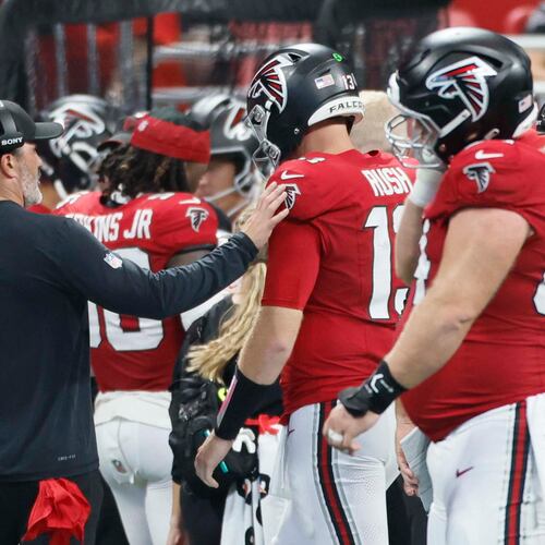Atlanta Falcons head coach Kevin Stefanski tries to speak with quarterback Cooper Rush after an interception during the second half of Sunday's game against the Carolina Panthers. (Miguel Martinez/AJC)