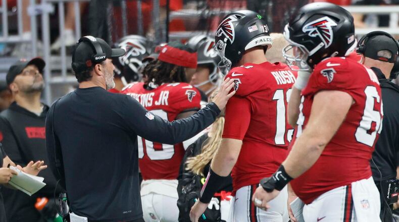 Atlanta Falcons head coach Kevin Stefanski tries to speak with quarterback Cooper Rush after an interception during the second half of Sunday's game against the Carolina Panthers. (Miguel Martinez/AJC)