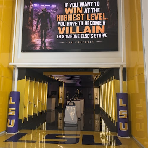 A quote hangs above a trophy display room near the entrance of the LSU Football Operations Center Monday, Aug. 31, 2026, in Baton Rouge, La. (AP Photo/Brett Martel)