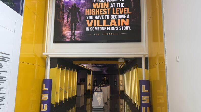 A quote hangs above a trophy display room near the entrance of the LSU Football Operations Center Monday, Aug. 31, 2026, in Baton Rouge, La. (AP Photo/Brett Martel)