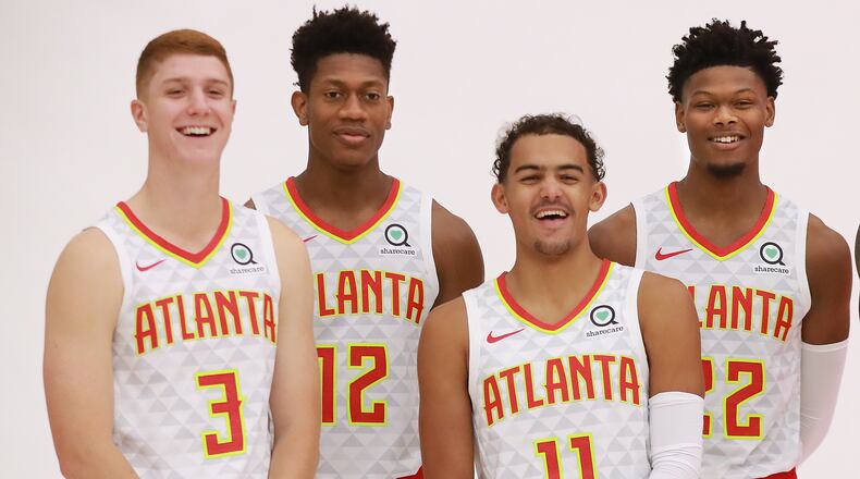 Hawks players Kevin Huerter (from left), De'Andre Hunter, Trae Young, and Cam Reddish share a laugh during team photos on media day on Monday, Sept. 30, 2019, in Atlanta.