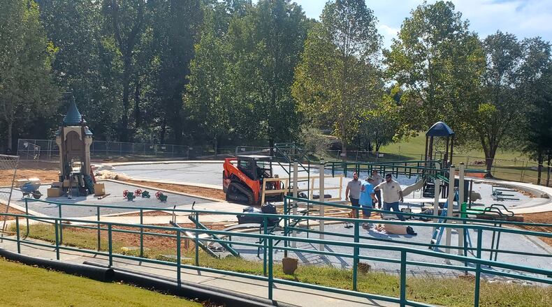 Construction workers in Dacula putting the finishing touches on the the Maple Creek Park playground. (Courtesy City of Dacula)