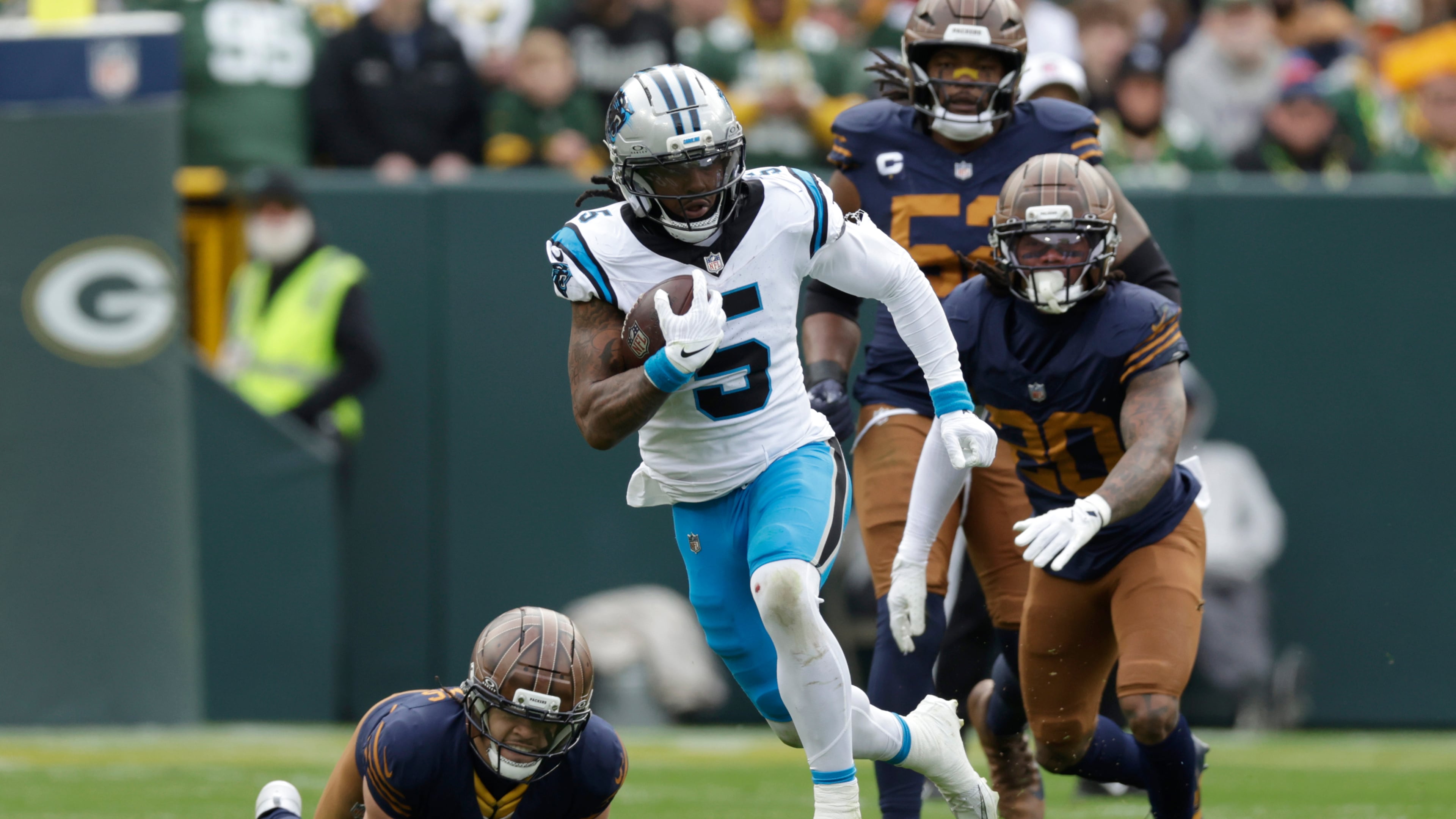Carolina Panthers running back Rico Dowdle (5) runs for a first down against the Green Bay Packers during the first half of an NFL football game Sunday, Nov. 2, 2025, in Green Bay, Wis. (AP Photo/Matt Ludtke)