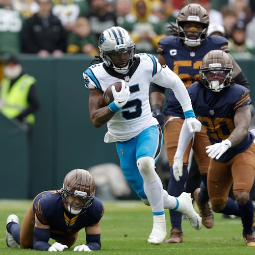 Carolina Panthers running back Rico Dowdle (5) runs for a first down against the Green Bay Packers during the first half of an NFL football game Sunday, Nov. 2, 2025, in Green Bay, Wis. (AP Photo/Matt Ludtke)