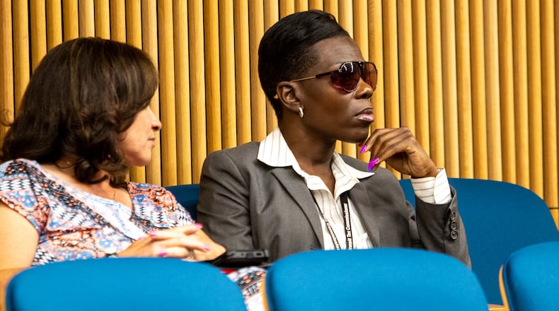 Tax commissioner Tiffany Porter, right, briefly attends the Gwinnett County Board of Commissions meeting Tuesday, June 15, 2021. The City of Grayson filed a lawsuit against Porter after she declined to collect their municipal taxes. (Jenni Girtman for The Atlanta Journal-Constitution)