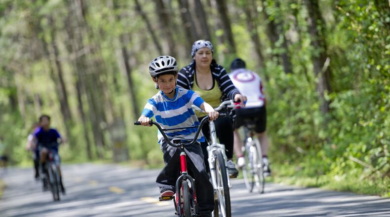 Families and Lycra-clad bike enthusiasts alike enjoy the Silver Comet Trail, which starts in Smyrna and connects with the Chief Ladiga Trail near the Alabama line. AJC Staff