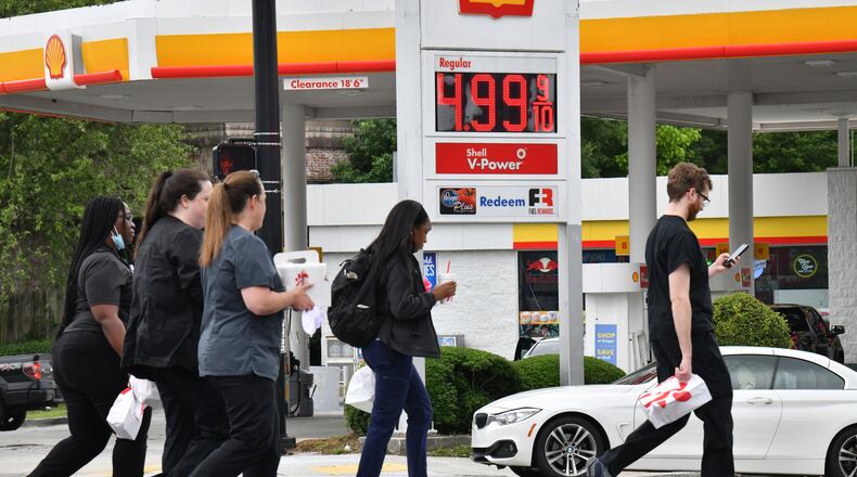 June 7, 2022 Atalnta - Lunch goers walk along a crosswalk near Shell gas station on Peachtree Road in Buckhead on Tuesday, June 6, 2022. Georgia gas prices hit new heights on Tuesday, according to AAA, with an average statewide cost of $4.33 for a gallon of regular unleaded fuel. That’s still well below the national average of $4.92 per gallon.(Hyosub Shin / Hyosub.Shin@ajc.com)