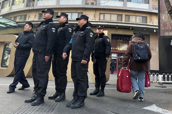 Chinese security personnel patrol the street near a meeting of family members of passengers who were on board the MH370 Malaysia Airline jet that went missing in 2014 in Beijing, China, Saturday, March 8, 2025. (AP Photo/Ng Han Guan)
