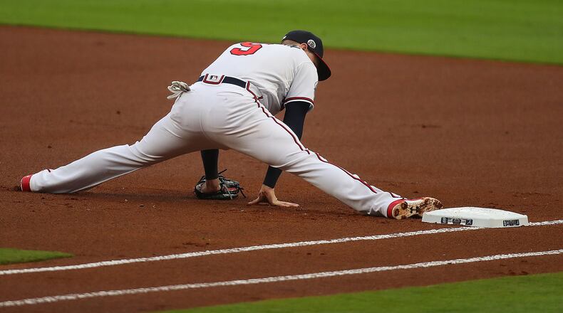 Freddie Freeman’s bat gets most of the attention, but it was his first-base defense Monday that was worth four or five runs for the Braves in Monday’s 4-3 loss to the Cubs. Here he’s pictured doing splits in attempt to cut the distance on a throw on a close play earlier this season. (Curtis Compton/AJC file photo)