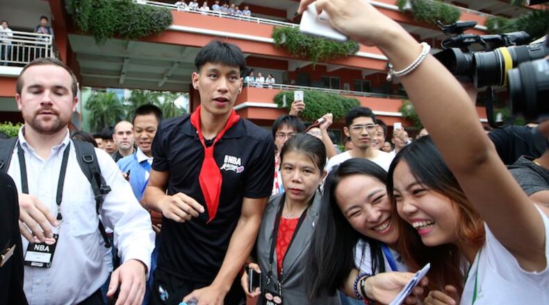 NBA basketball player Jeremy Lin of Charlotte Hornets, visits a school for the NBA Care Legacy Project in Shenzhen, south China's Guangdong province, Saturday, Oct. 10, 2015. Charlotte Hornets will play with Los Angeles Clippers in Oct. 11 in Shenzhen. (AP Photo/Kin Cheung)