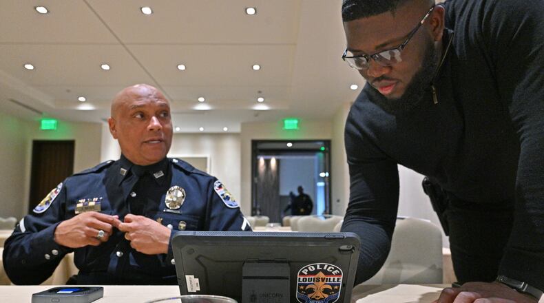 March 24, 2022 Atlanta - Detective Jay Moss (left) and Officer Robinson Desroches, both with Louisville Metro Police, set up a device for their recruiting event at Hyatt Centric Midtown Atlanta on Thursday, March 24, 2022. (Hyosub Shin / Hyosub.Shin@ajc.com)
