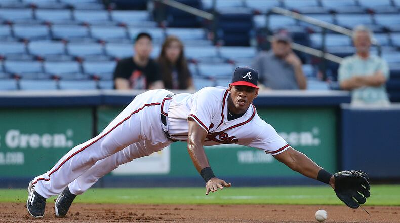 Braves new third baseman Hector Olivera dives just missing a single by Marlins’ Martin Prado. Curtis Compton / ccompton@ajc.com