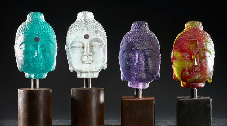 Four bookshelf Buddhas created by Marlene Rose, whose work is on show at Buckhead Art & Company through November 12. (Photo by David Monroe)