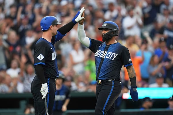 Detroit Tigers' Gleyber Torres, right, celebrates scoring with Dillon Dingler, left, against the Seattle Mariners in the fourth inning during a baseball game, Friday, July 11, 2025, in Detroit. (AP Photo/Paul Sancya)