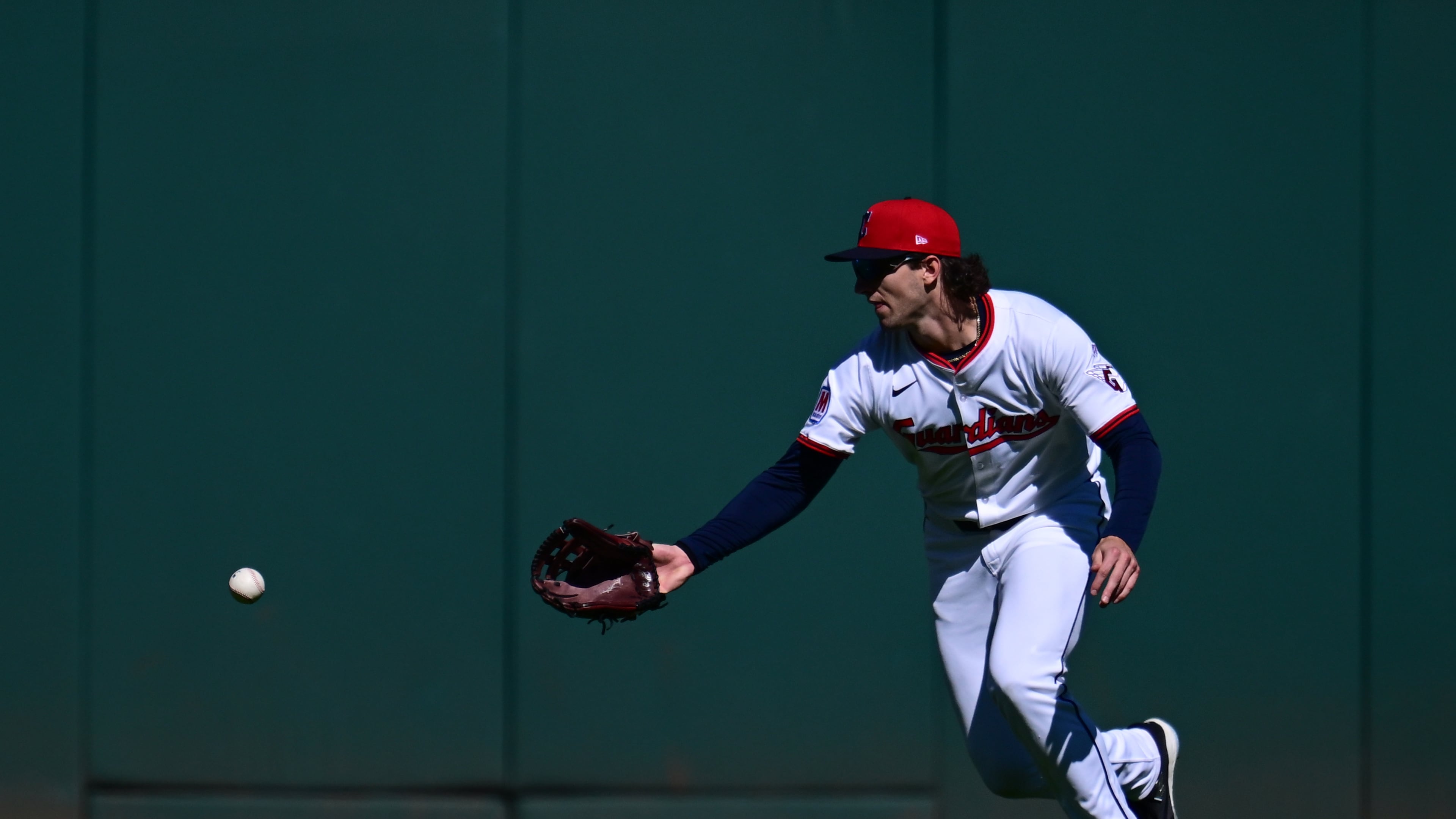 Cleveland Guardians center fielder Chase DeLauter misses a ball hit by Detroit Tigers' Gleyber Torres for a fielding error in the first inning of Game 2 of the American League Wild Card baseball playoff series in Cleveland, Wednesday, Oct. 1, 2025. (AP Photo/David Dermer)