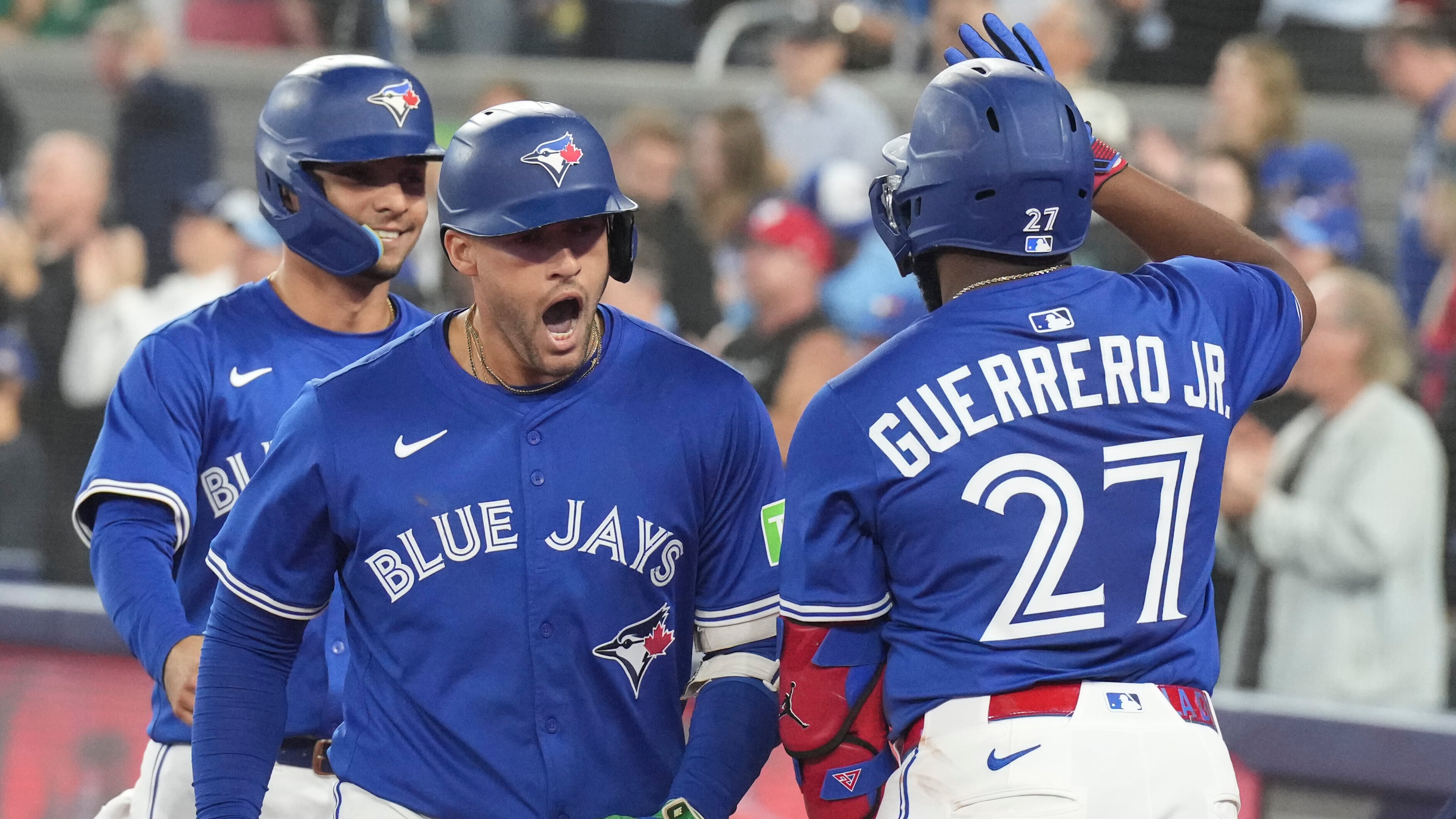 Toronto Blue Jays' George Springer (centre) celebrates his two-run home run against the Boston Red Sox with Vladimir Guerrero Jr. (27) during sixth inning MLB baseball action in Toronto on Thursday Sept. 25, 2025. (Chris Young/The Canadian Press via AP)