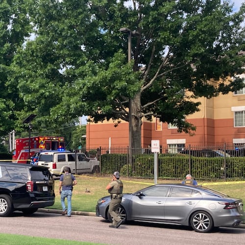 Law enforcement officers work the scene after a federal agent with the Memphis Safe Task Force shot and killed a person at a hotel in Memphis, Tenn., on Wednesday, July 8, 2026. (Natalie Van Gundy/Daily Memphian via AP)